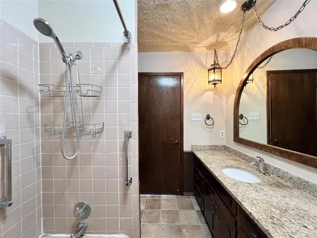 a view of a bathroom with bathtub and shower