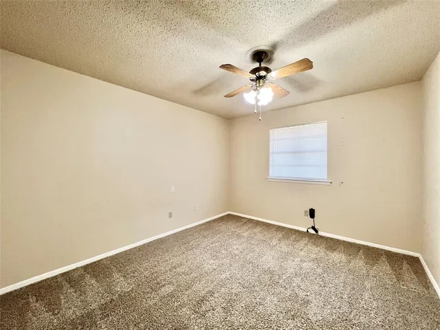 a view of a big room with closet and a ceiling fan