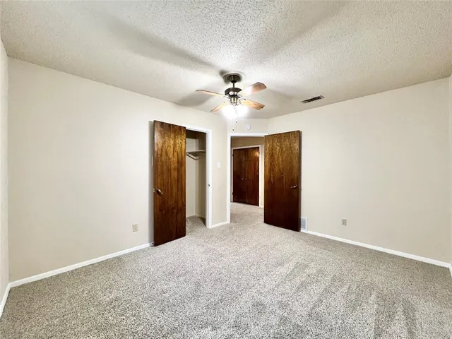 a bathroom with a granite countertop sink a mirror and a bathtub
