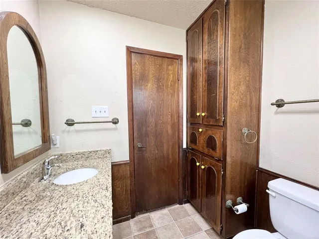 an empty room with a window and ceiling fan