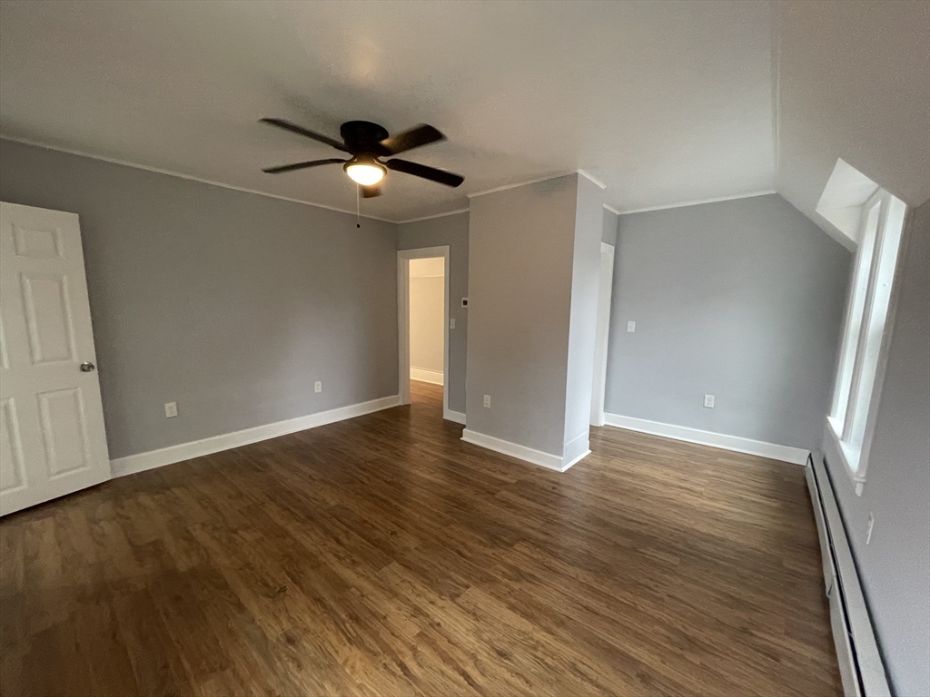 59 High Street Warren, MA 01083 - Photo 23 of 42 a view of an empty room with wooden floor and a ceiling fan