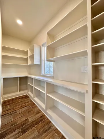 a view of walk in closet with empty racks