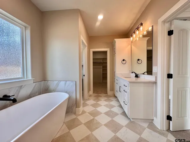 a bathroom with a double vanity sink mirror and shower