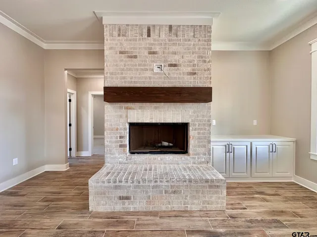 a living room with a fireplace and a wooden floor