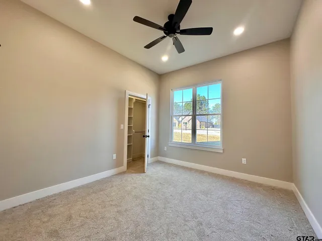 a view of a livingroom with a ceiling fan and window
