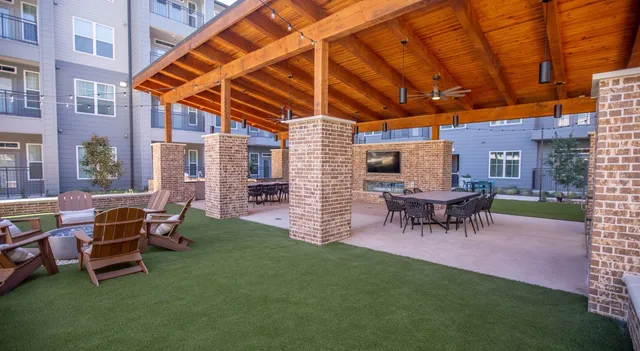 a view of a backyard with table and chairs
