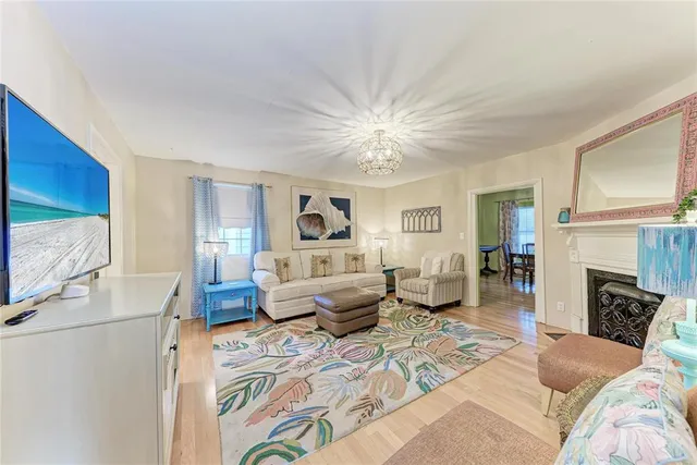 a view of a livingroom with furniture a flat screen tv and a chandelier