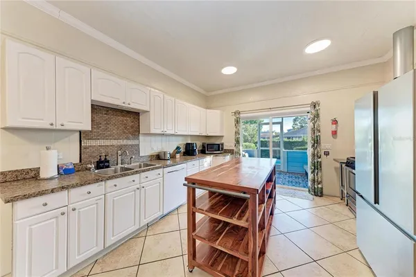 a bathroom with a granite countertop sink a toilet and a shower