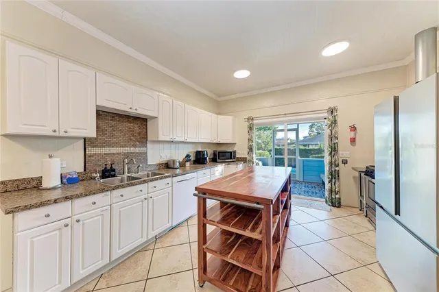 a bedroom with double bed and a chandelier