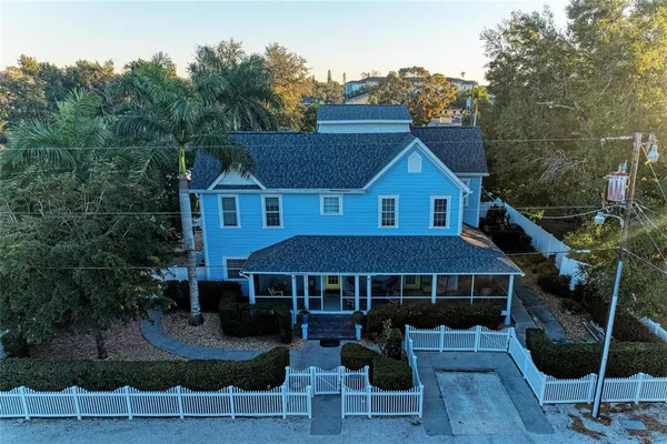 a front view of a house with plants
