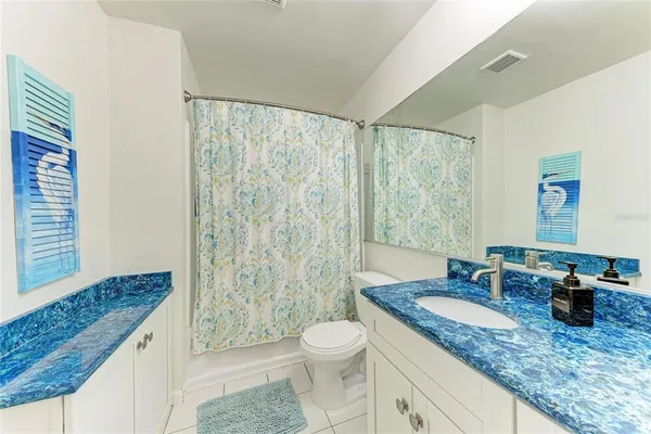 a bathroom with a sink toilet a mirror and shower