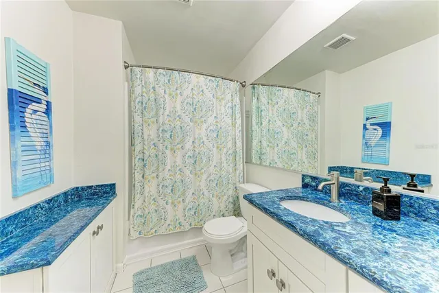 a bathroom with a sink toilet a mirror and shower