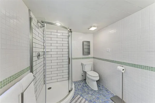 a view of a patio with couches table and chairs with wooden fence and plants
