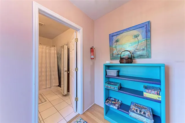 an aerial view of a city with lots of residential buildings and ocean view in back