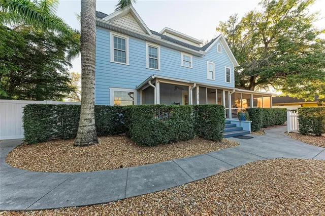 a front view of a house with plants