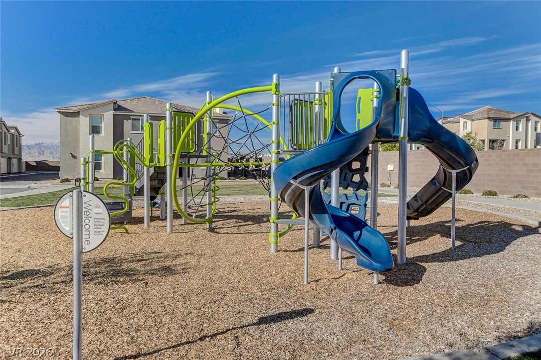 6924 Spicy Merlot Street North Las Vegas, NV 89086 - Photo 43 of 83 A vibrant playground awaits, featuring modern equipment and soft wood chips, nestled within a residential community.