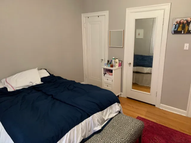 a bedroom with a bed and a mirror
