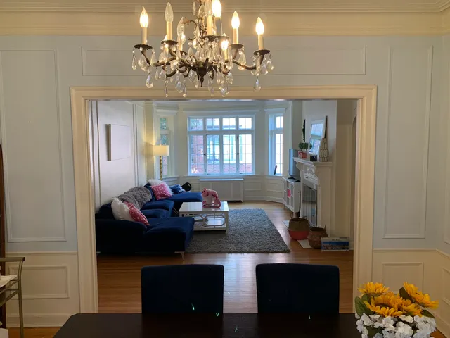 a living room with furniture and a chandelier