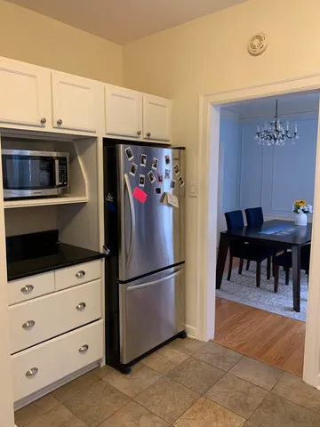 a kitchen with stainless steel appliances a refrigerator and cabinets