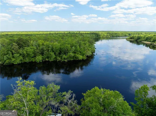 an aerial view of a houses with a lake view