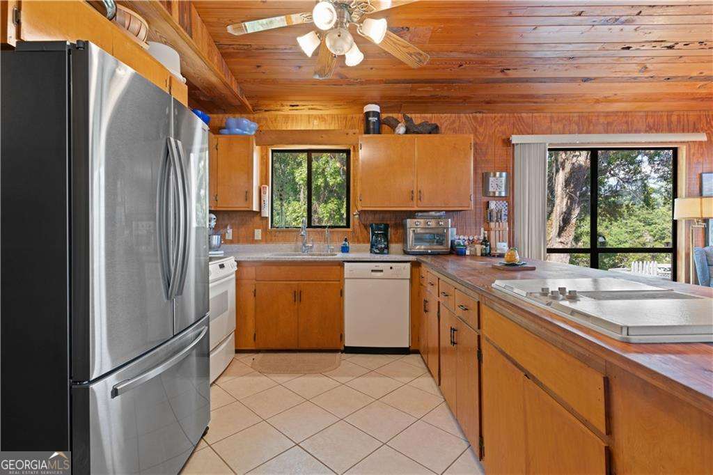 4631 Bailey Mill Road White Oak, GA 31568 - Photo 18 of 38 a kitchen with a sink window and cabinets