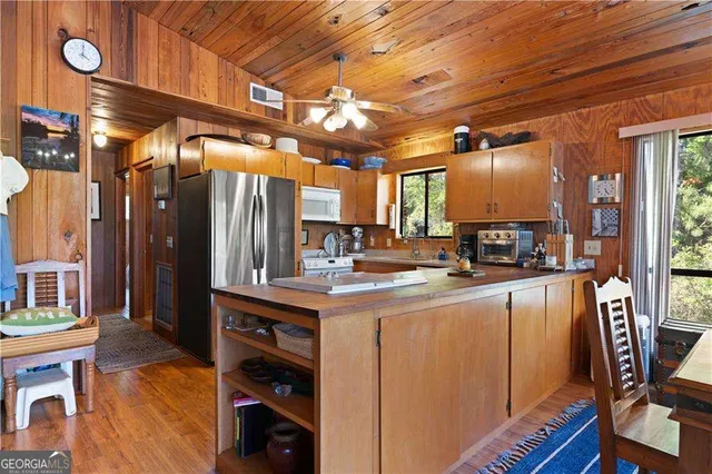 a kitchen with stainless steel appliances granite countertop a sink a stove and a refrigerator