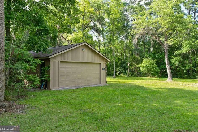a house with huge green field in front of it