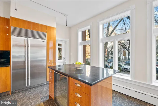 a kitchen with stainless steel appliances granite countertop a refrigerator and a sink