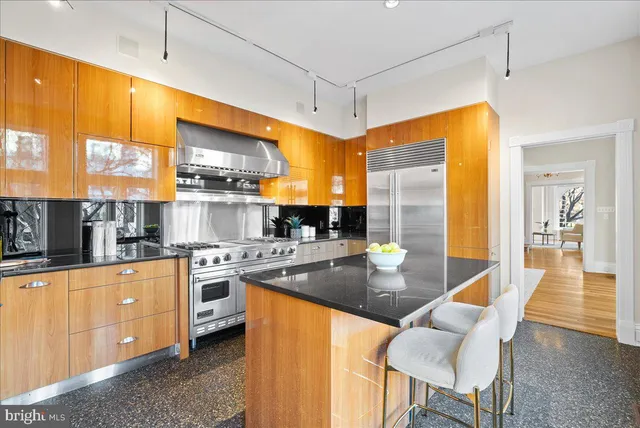 a kitchen with stainless steel appliances granite countertop a stove a sink dishwasher and a refrigerator