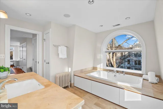 a large bedroom with a bed and a window