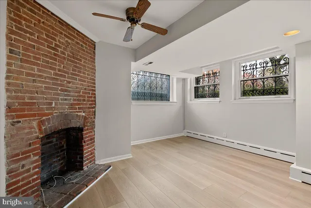 a view of empty room with windows and fireplace