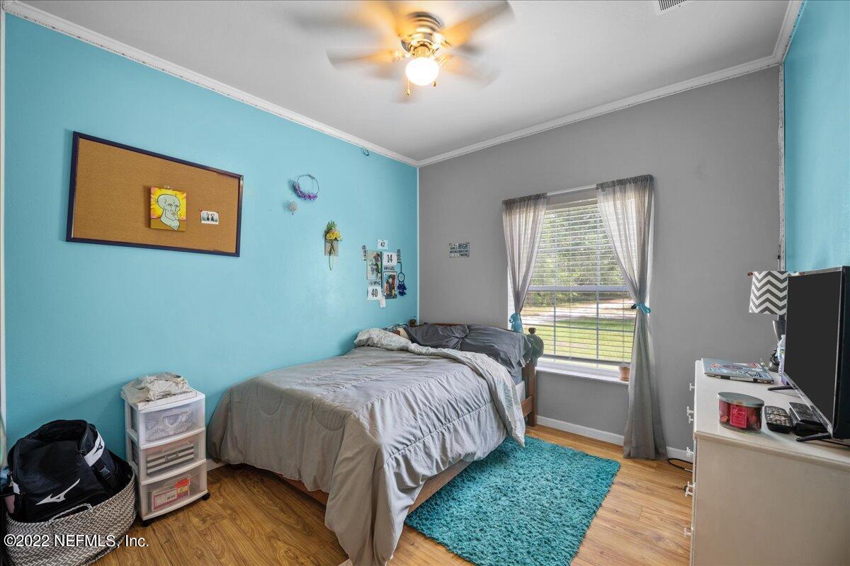 101 Sand Lake Road Interlachen, FL 32148 - Photo 13 of 40 a bedroom with a bed and a window