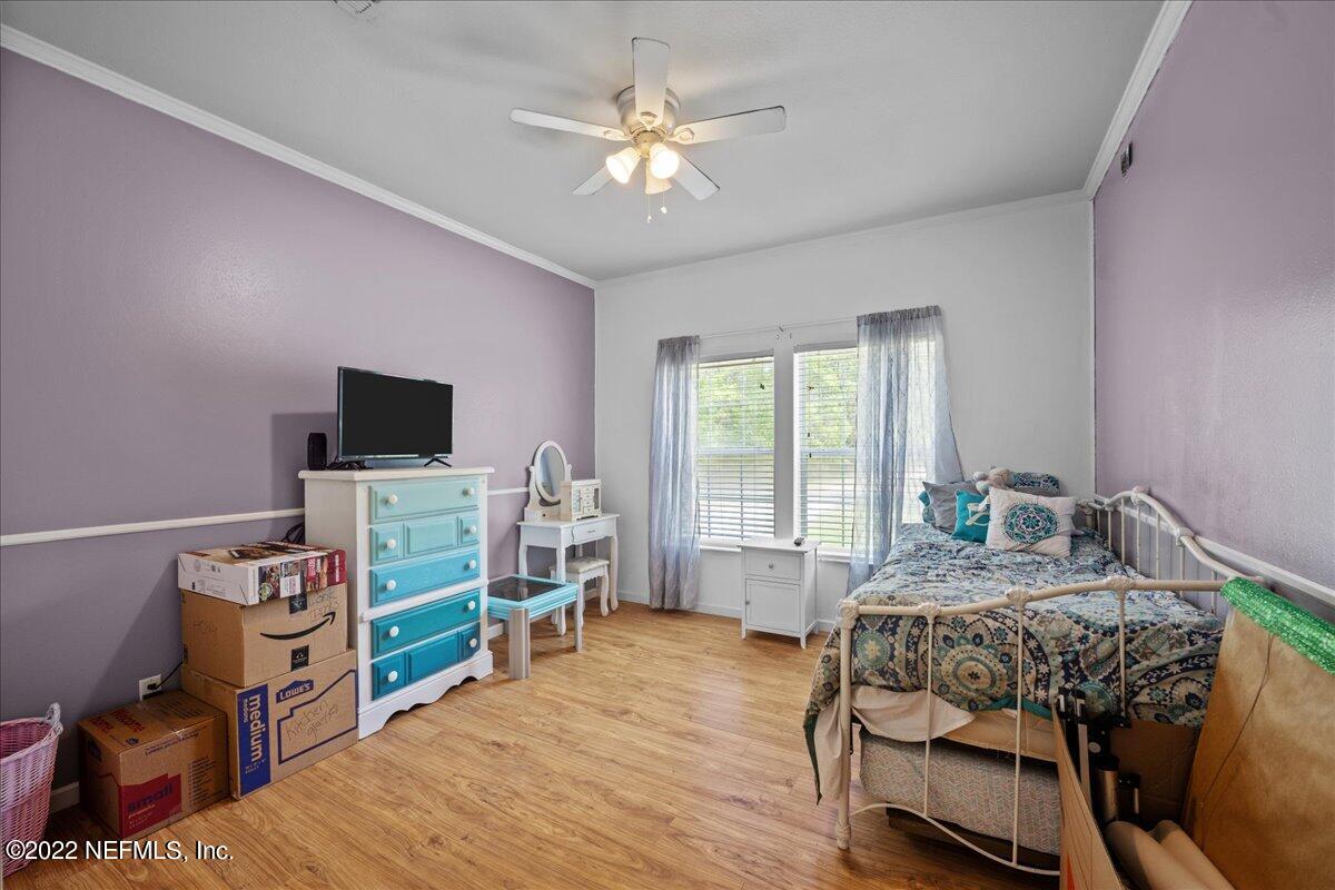 101 Sand Lake Road Interlachen, FL 32148 - Photo 15 of 40 a bedroom with furniture and a flat screen tv