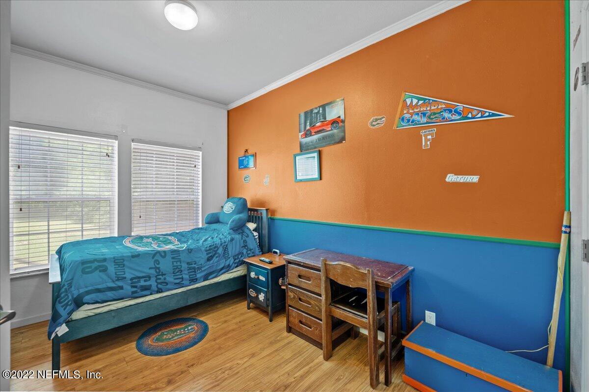 101 Sand Lake Road Interlachen, FL 32148 - Photo 16 of 40 a bedroom with furniture and a window