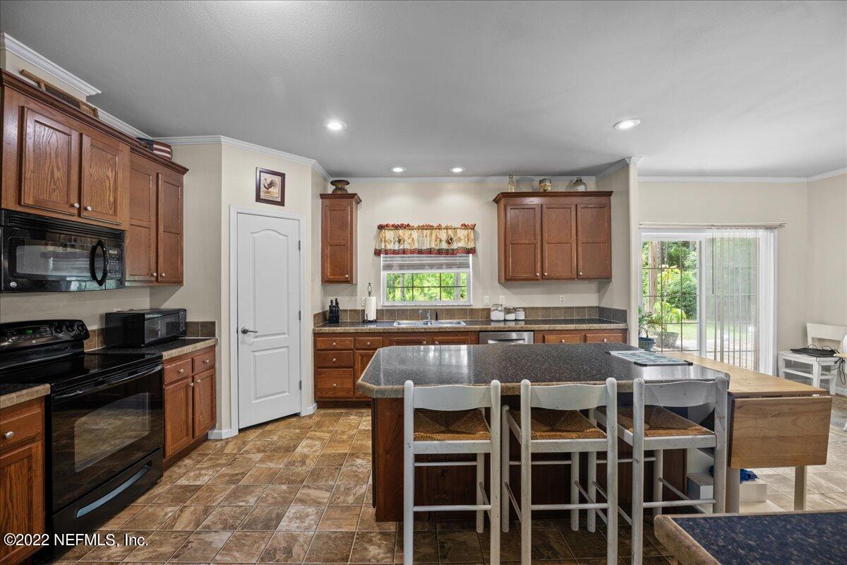 101 Sand Lake Road Interlachen, FL 32148 - Photo 2 of 40 a kitchen with large windows and refrigerator