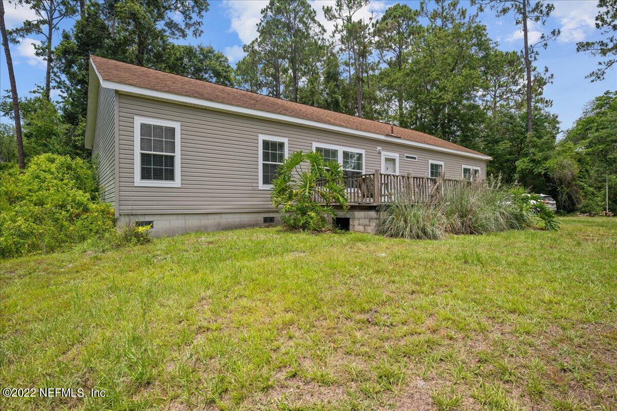 101 Sand Lake Road Interlachen, FL 32148 - Photo 31 of 40 a view of a house with backyard and garden