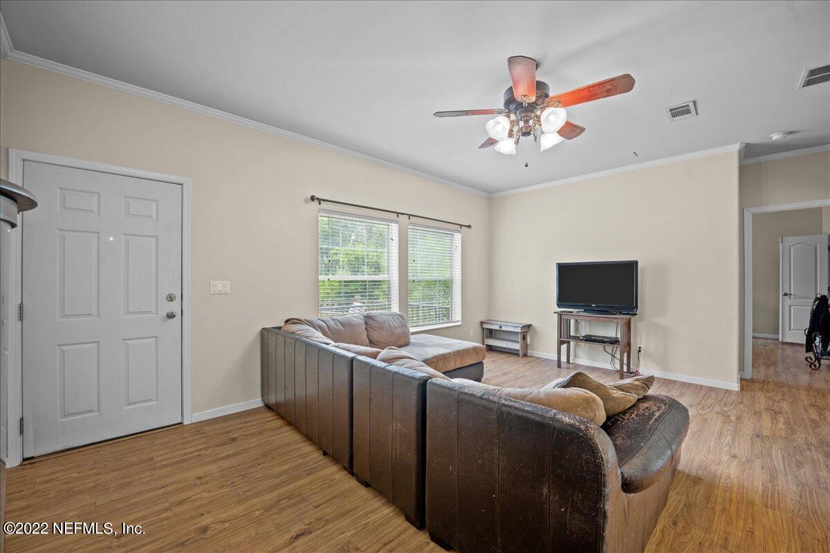 101 Sand Lake Road Interlachen, FL 32148 - Photo 8 of 40 a living room with furniture window and a flat screen tv