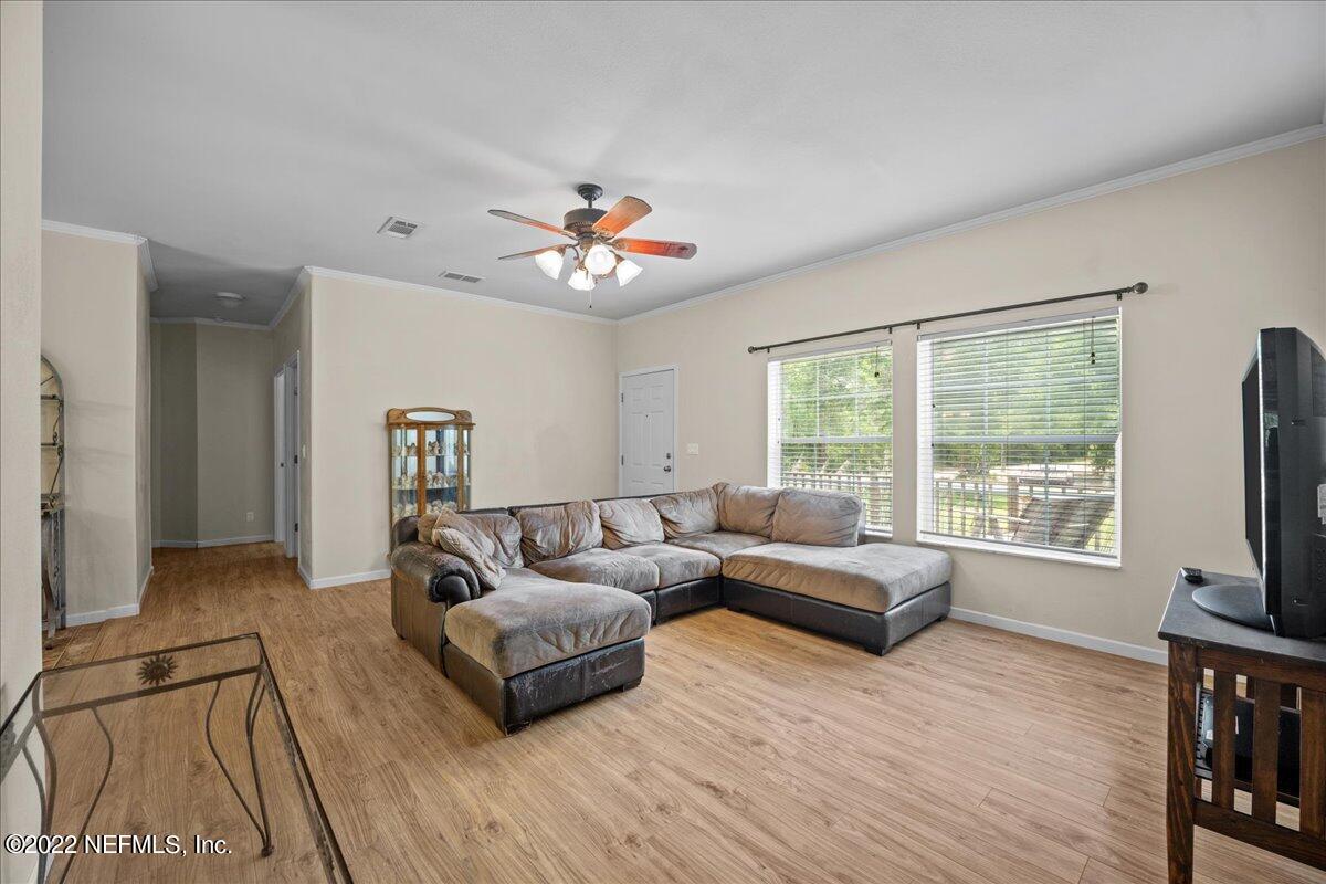 101 Sand Lake Road Interlachen, FL 32148 - Photo 9 of 40 a living room with furniture and a flat screen tv