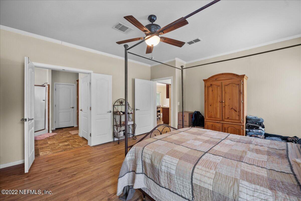 101 Sand Lake Road Interlachen, FL 32148 - Photo 10 of 40 a bedroom with a bed and a ceiling fan