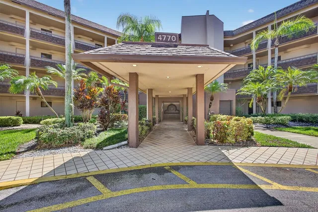 a view of a patio with table and chairs potted plants