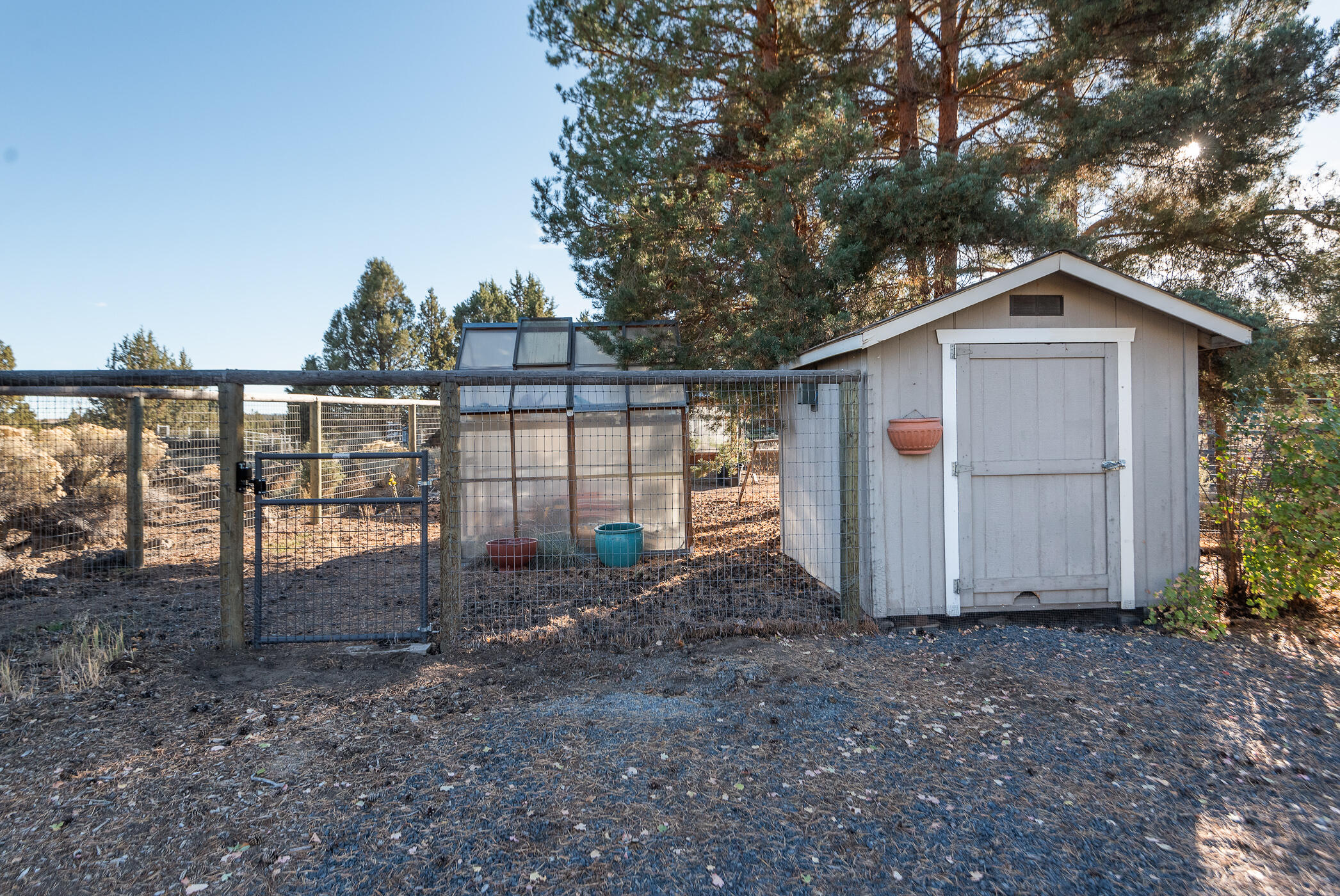 60835 Jennings Road Bend, OR 97702 - Photo 35 of 53 The garden area includes deer fencing, garden shed two green houses and raised planters