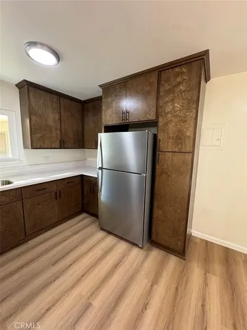 a kitchen with a refrigerator and a more cabinets