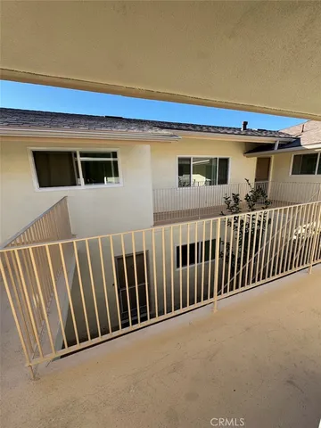 a view of a house with wooden fence