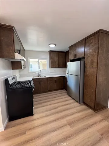 a kitchen with stainless steel appliances granite countertop a refrigerator stove a sink and dishwasher