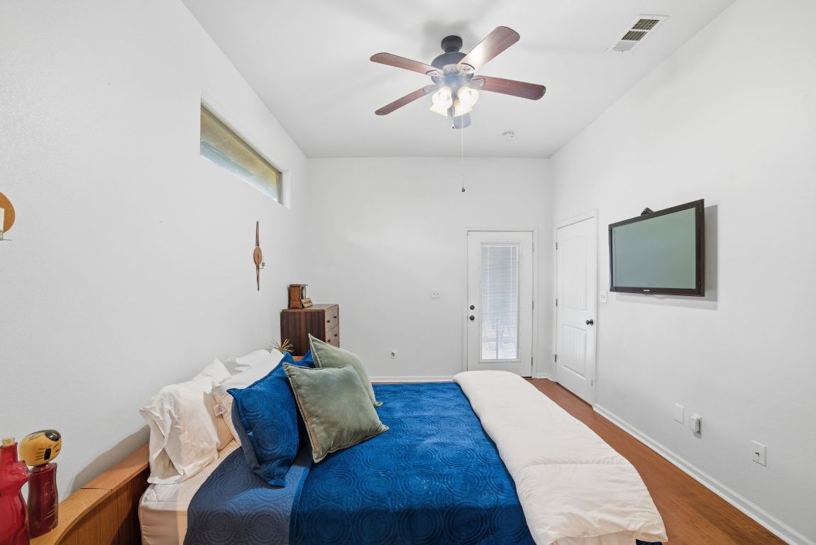 5704 Roundup Street Leander, TX 78645 - Photo 14 of 29 Bedroom with a ceiling fan and wood finished floors