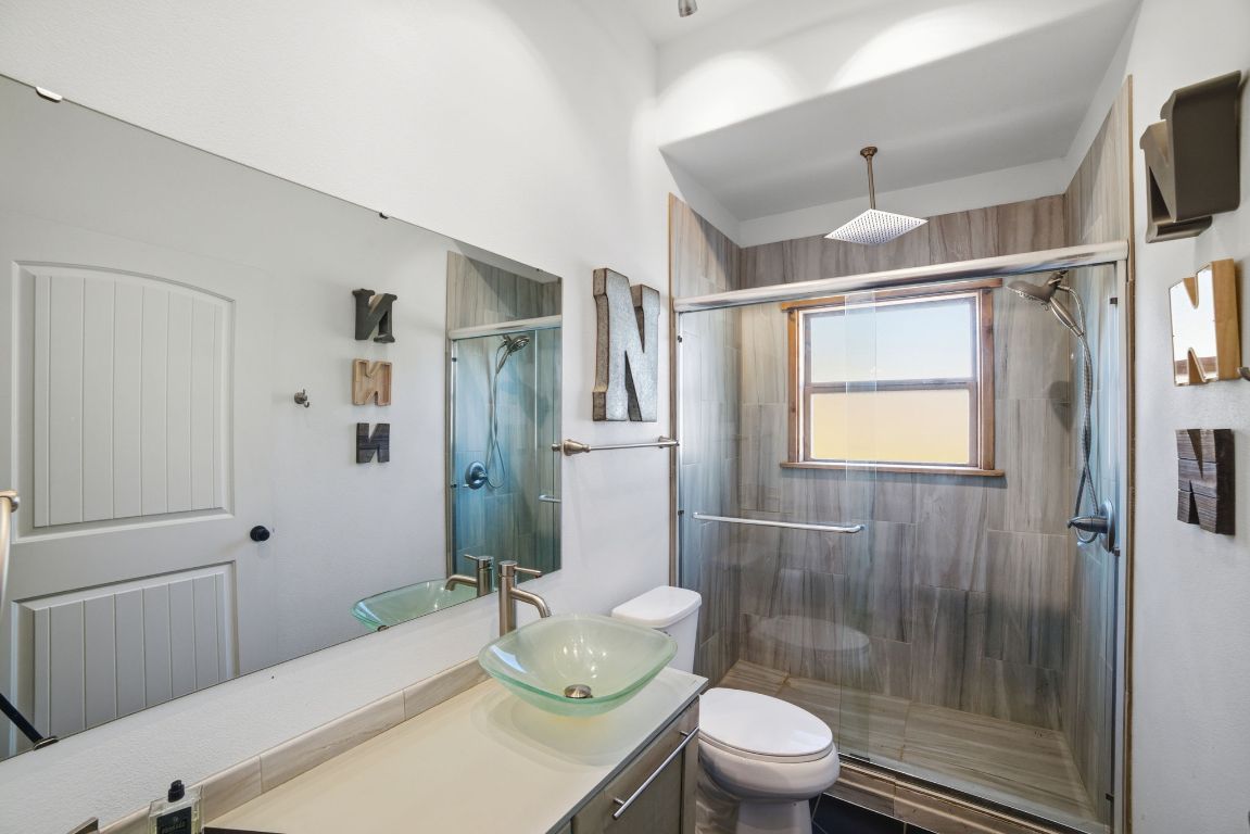 5704 Roundup Street Leander, TX 78645 - Photo 18 of 29 Bathroom with vanity and a stall shower