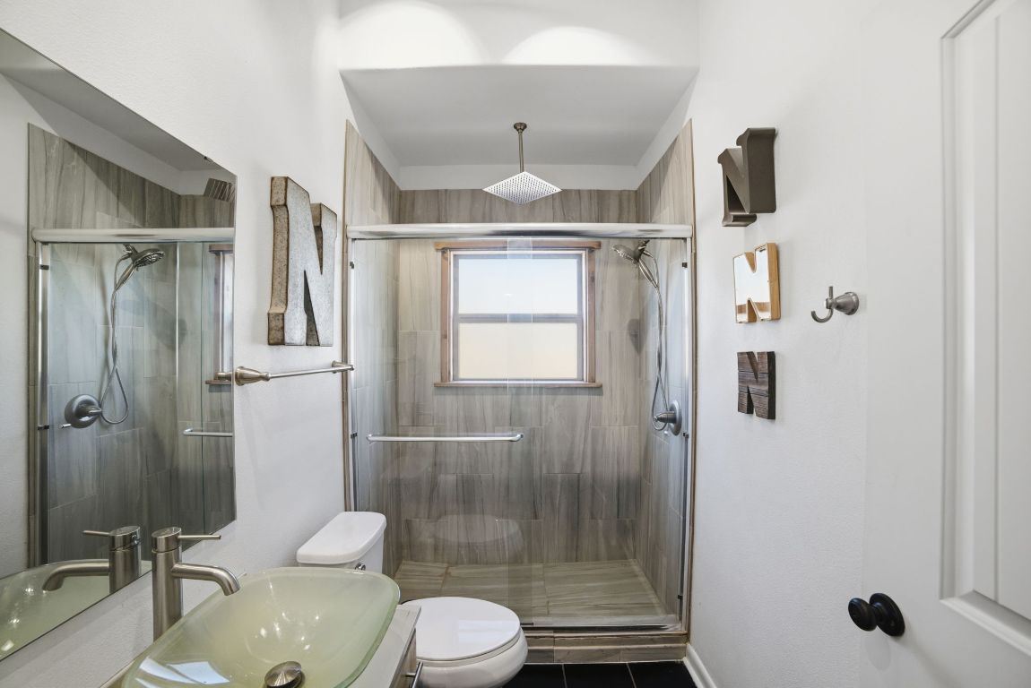 5704 Roundup Street Leander, TX 78645 - Photo 19 of 29 Bathroom featuring vanity, a stall shower, and tile patterned floors