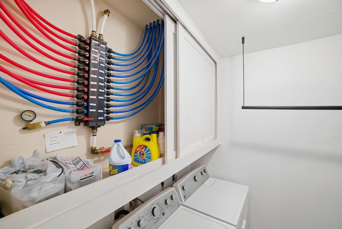 5704 Roundup Street Leander, TX 78645 - Photo 22 of 29 Washroom featuring washer and clothes dryer