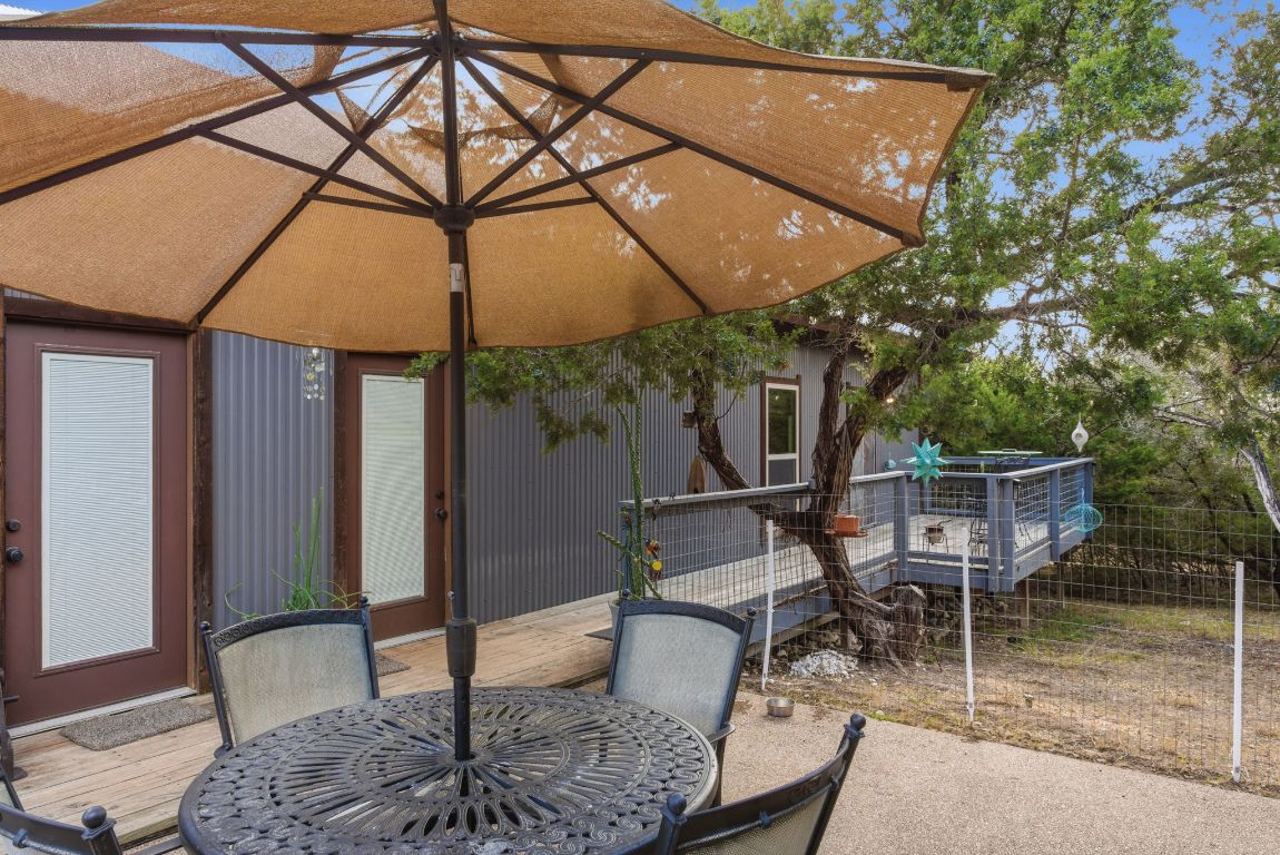 5704 Roundup Street Leander, TX 78645 - Photo 29 of 29 View of patio featuring outdoor dining area and a wooden deck