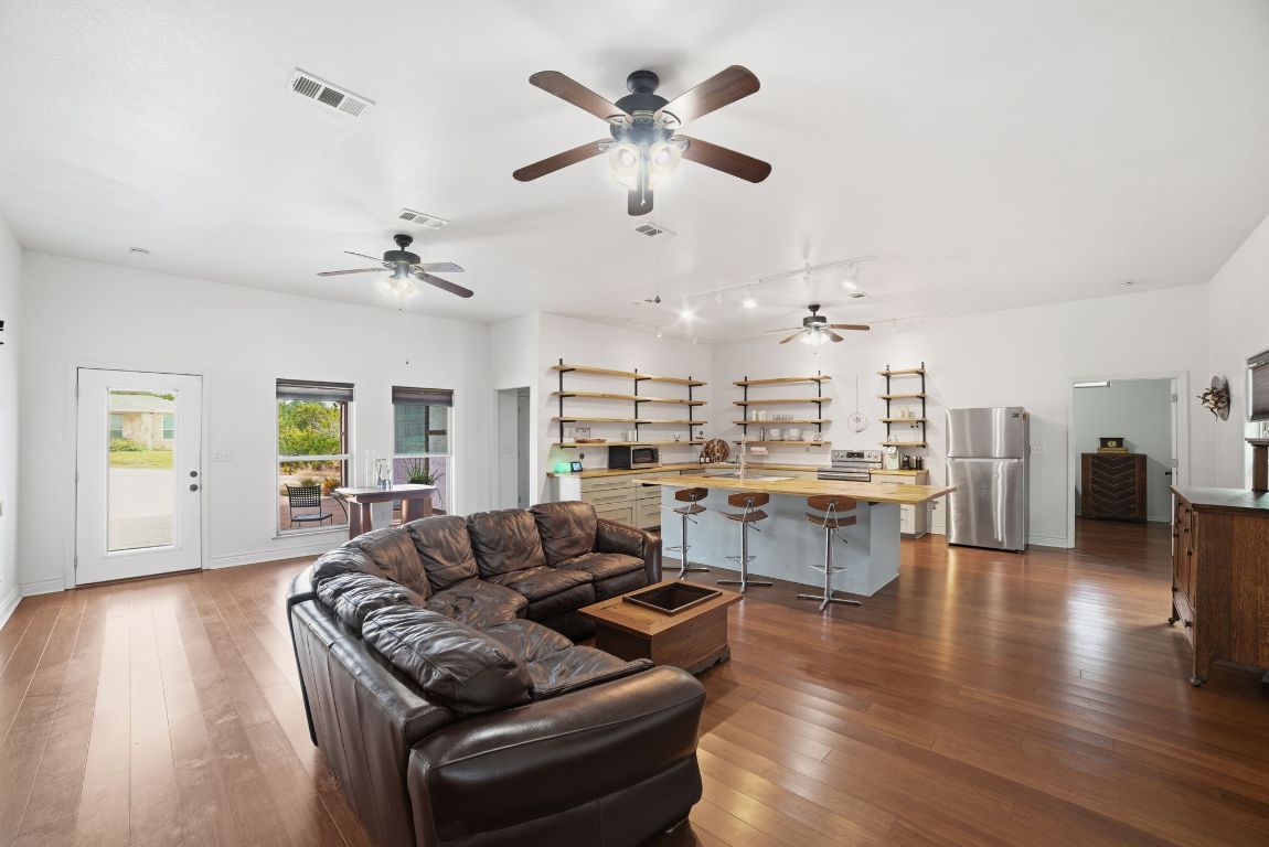 5704 Roundup Street Leander, TX 78645 - Photo 5 of 29 Living area with dark wood-style flooring and baseboards